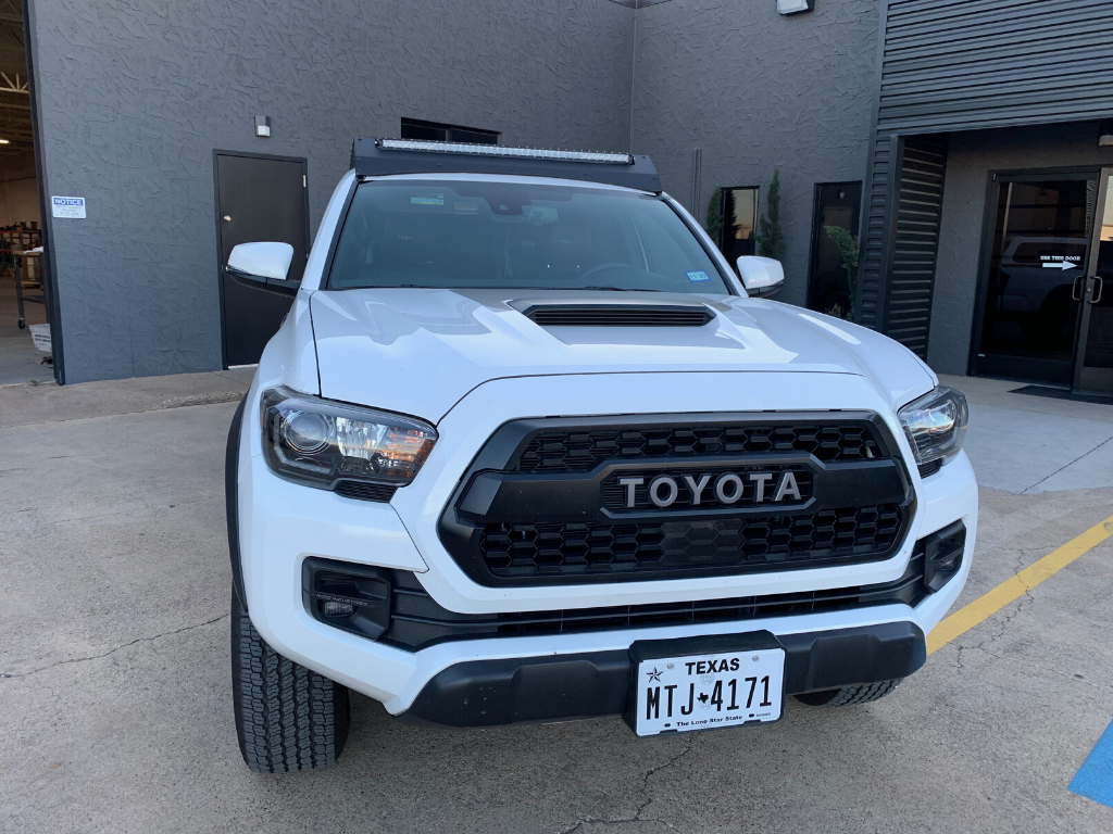 Front view of Economy Roof Rack on a white Toyota Tacoma - Cali Raised LED