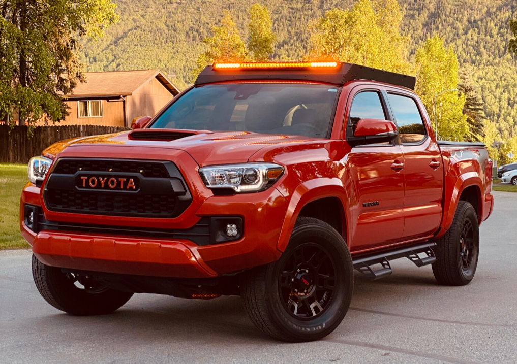 Front view of Economy Roof Rack with amber light baron a red Toyota Tacoma - Cali Raised LED