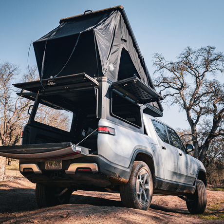 Rivian R1T with Inca4x4 aluminum wedge camper in travel position