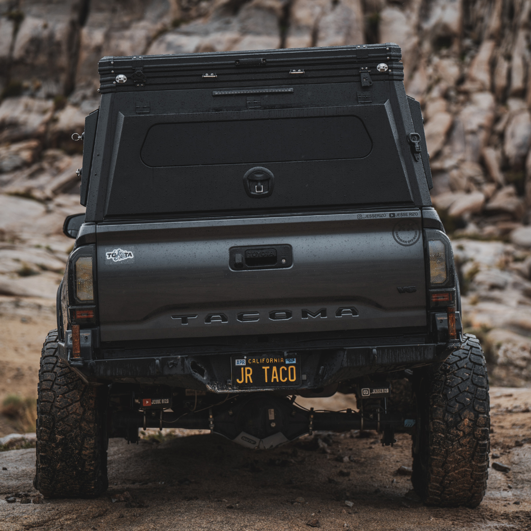 Rear view of Toyota Tacoma with Inca4x4 aluminum pop-up truck camper