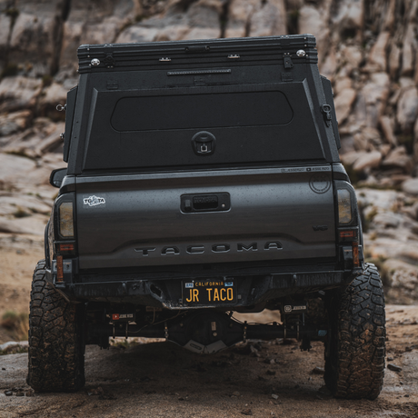 Rear view of Toyota Tacoma with Inca4x4 aluminum pop-up truck camper