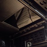 Interior view of Inca4x4 Tacoma aluminum camper sleeping platform and MOLLE storage