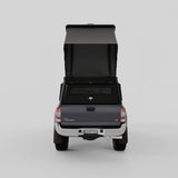 Rear view of Inca4x4 aluminum Tacoma camper with pop-up roof open