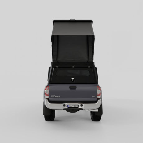 Rear view of Inca4x4 aluminum Tacoma camper with pop-up roof open