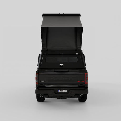 Rear three-quarter view of Inca4x4 aluminum camper on Ford full-size pickup