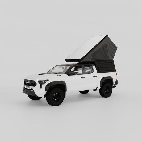 Front three quarter view of Toyota Tacoma with Inca4x4 pop-up truck camper