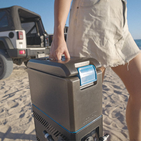 Joolca HOTTAP Go portable shower carried to beach from Jeep camp setup